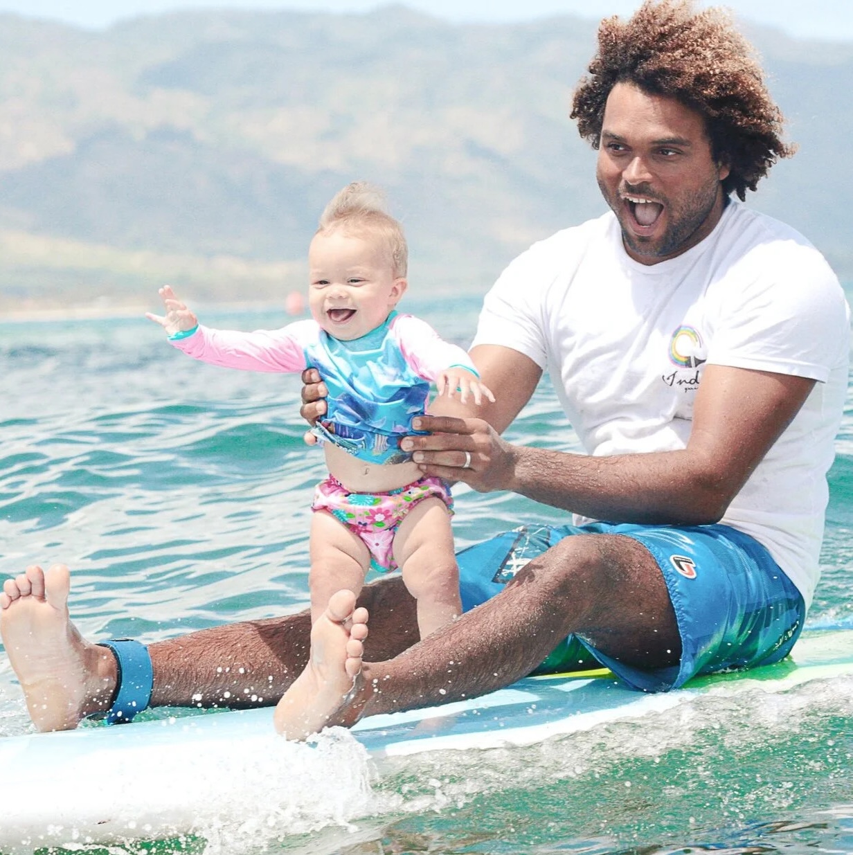 Sergio Lima with a surfboard on the beach